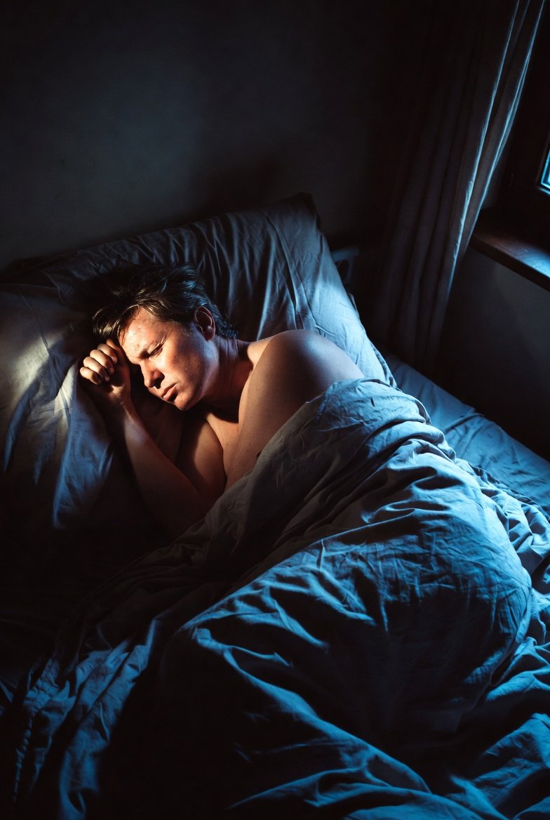 Person awake at night with discomfort